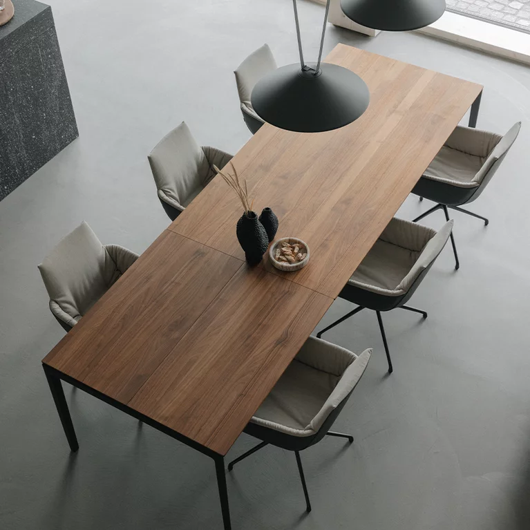 solid extendable table with metal frame and matching lui léger chairs dining table tak made of solid wood and extendable in walnut with metal frame in matt black and the lui léger chair group